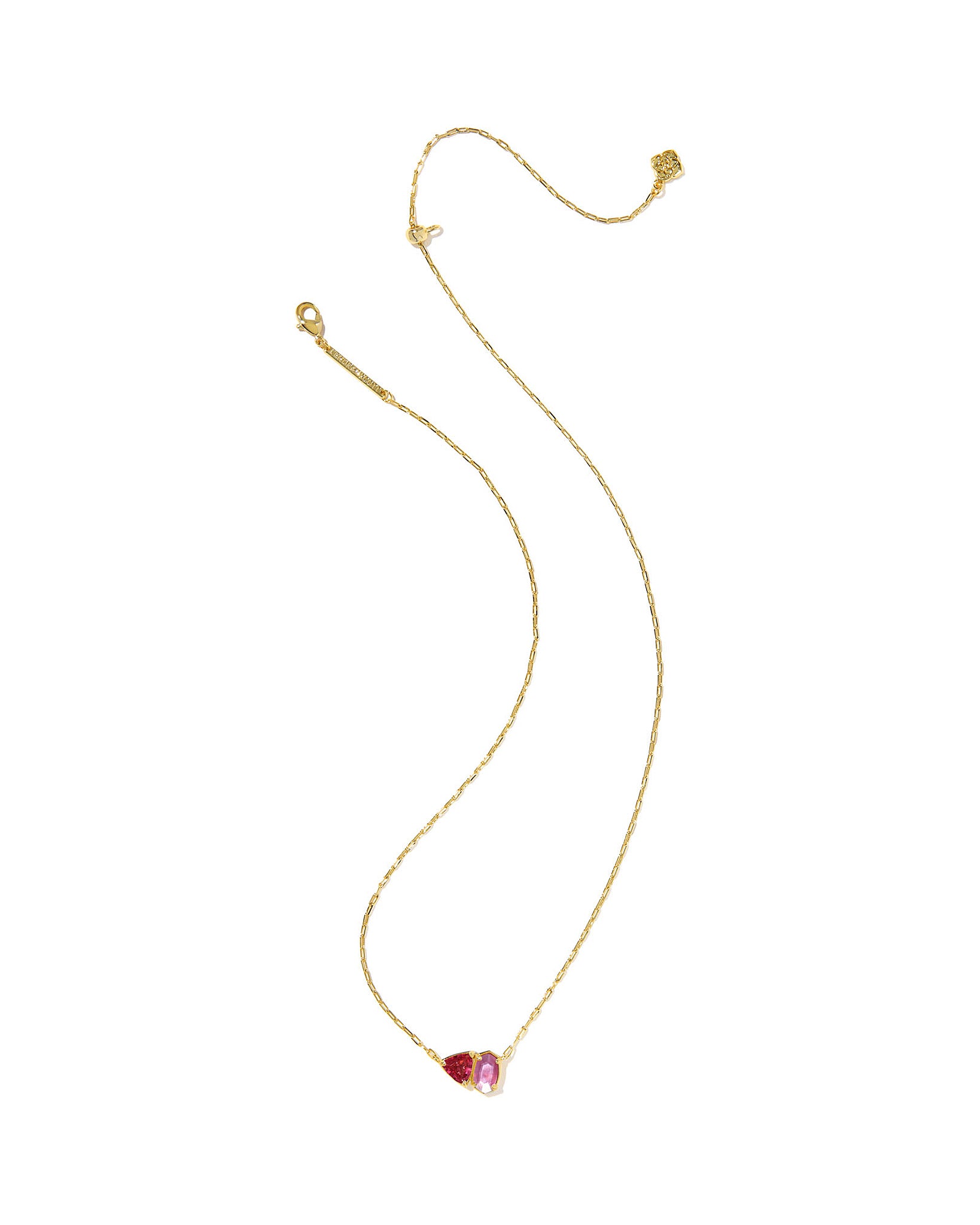 Gold necklace with a geometric pink and red pendant on a white background