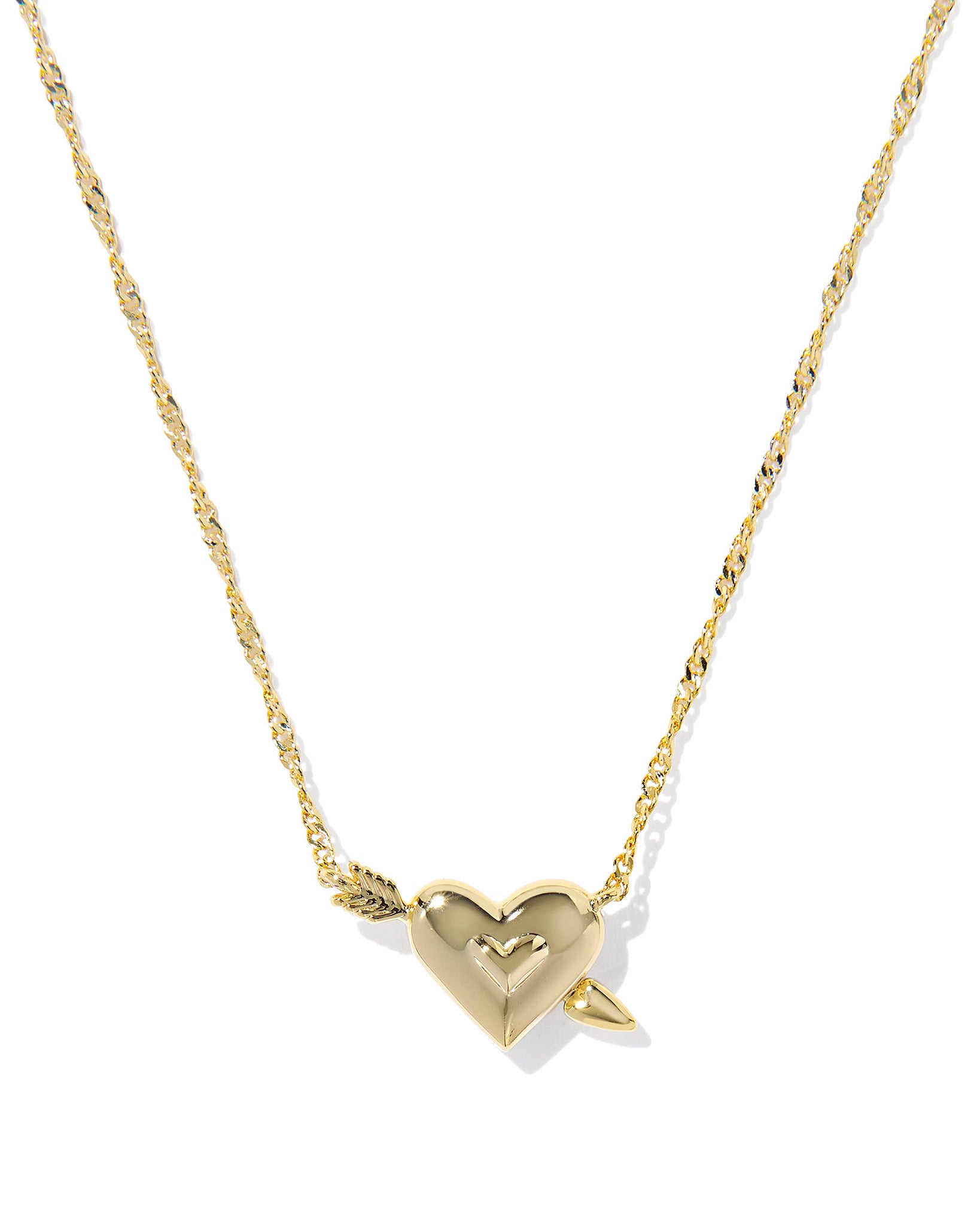 Gold necklace with gold heart shaped pendant with an arrow through it on a white background