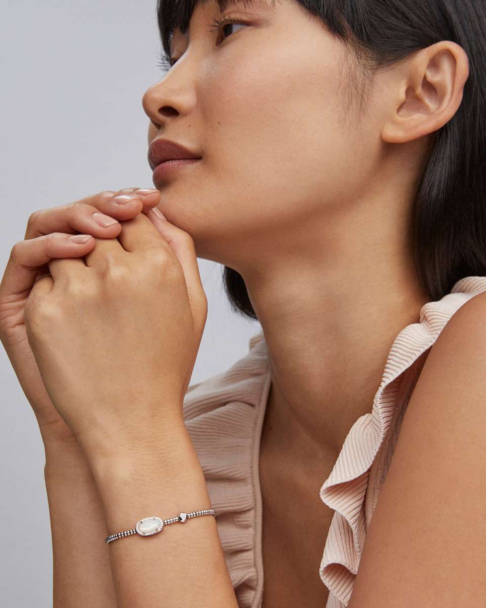 Woman wearing a bracelet with a subtle background