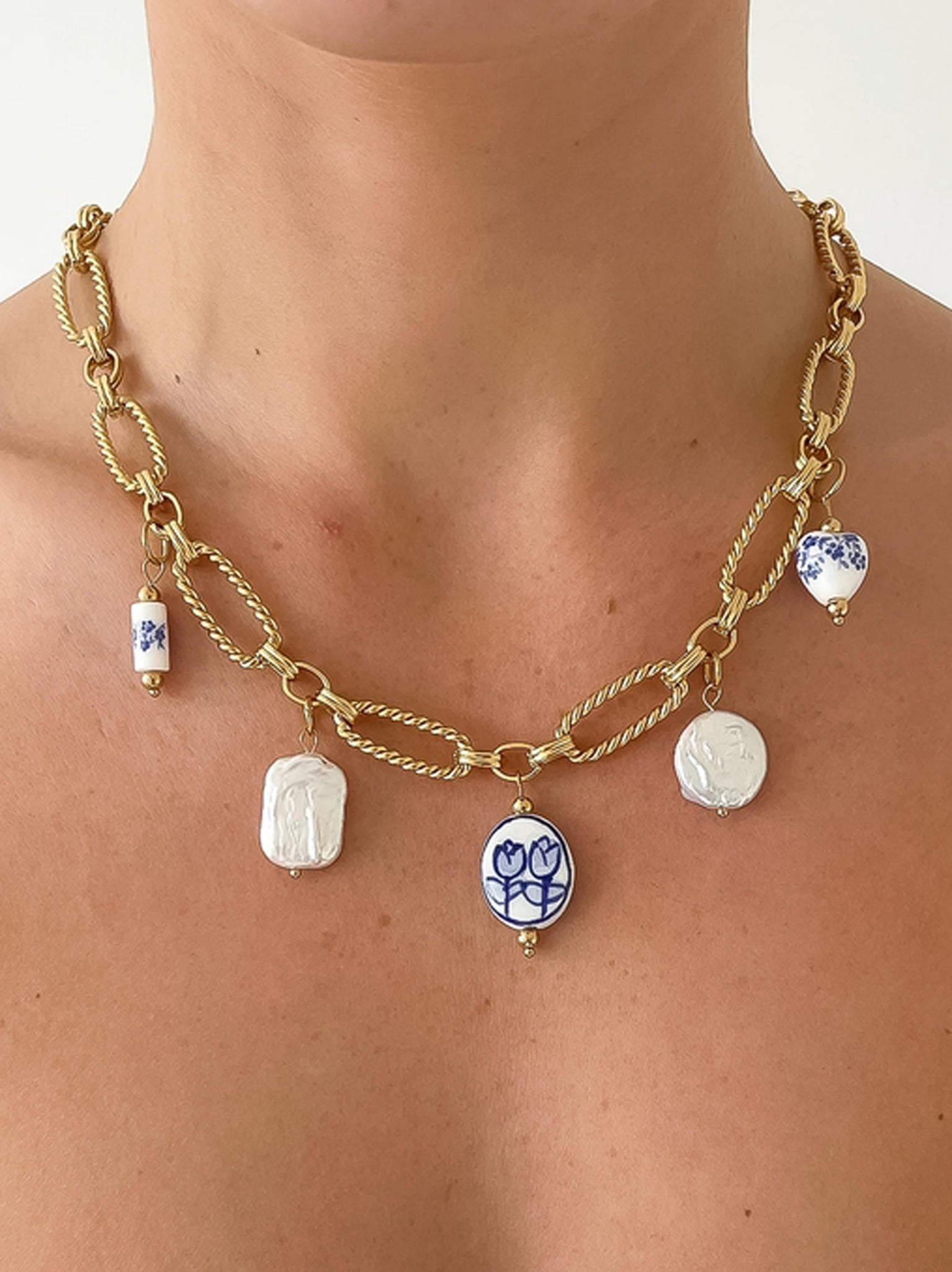 Flanerie Riela Blue Floral Ceramic and Faux Pearl Statement Charm Necklace in Gold Plated