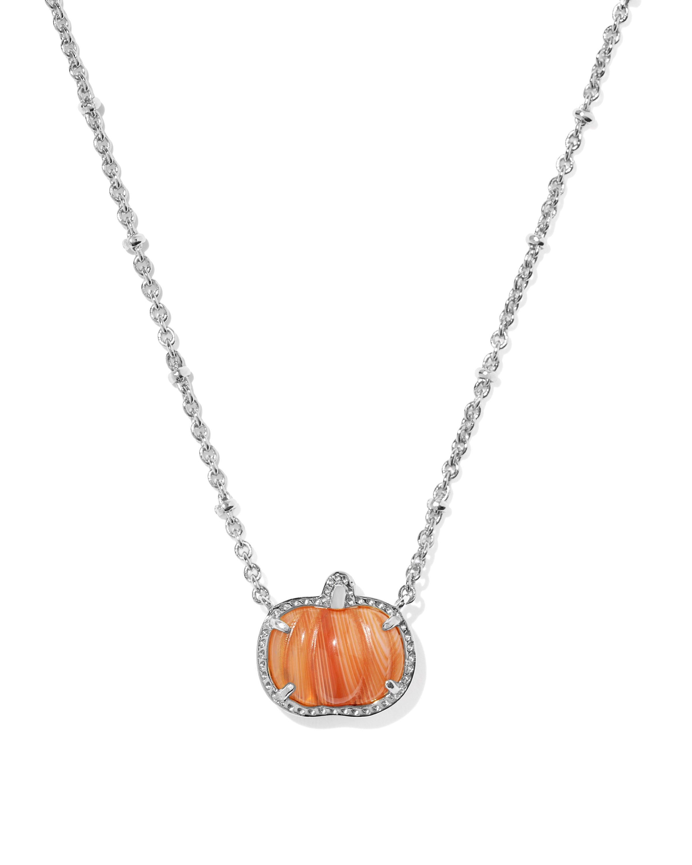 A silver chain necklace featuring a pumpkin-shaped pendant with orange marbled inlay and a border of small clear stones, shown on a plain white background.