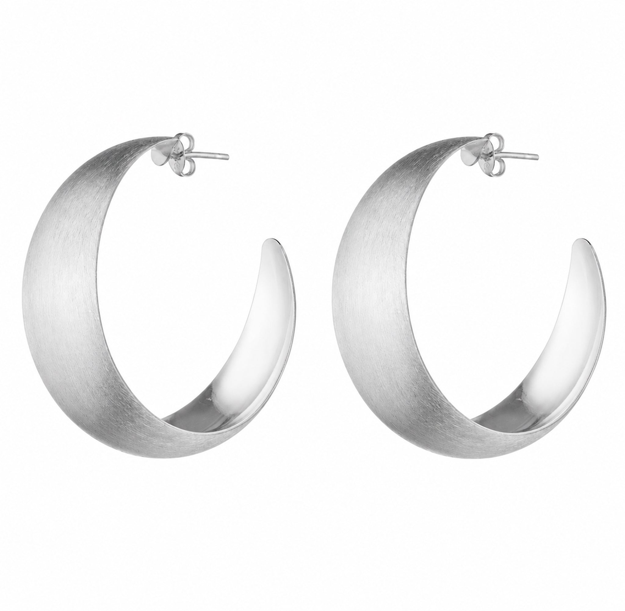 A pair of large, open crescent-shaped hoop earrings in a brushed silver finish, shown on a plain white background.