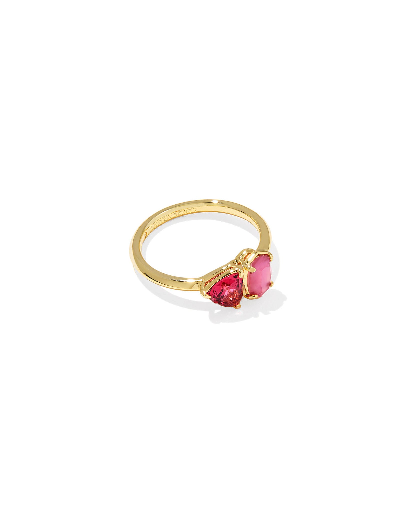 Gold ring with pink and red geometric gemstones on a white background