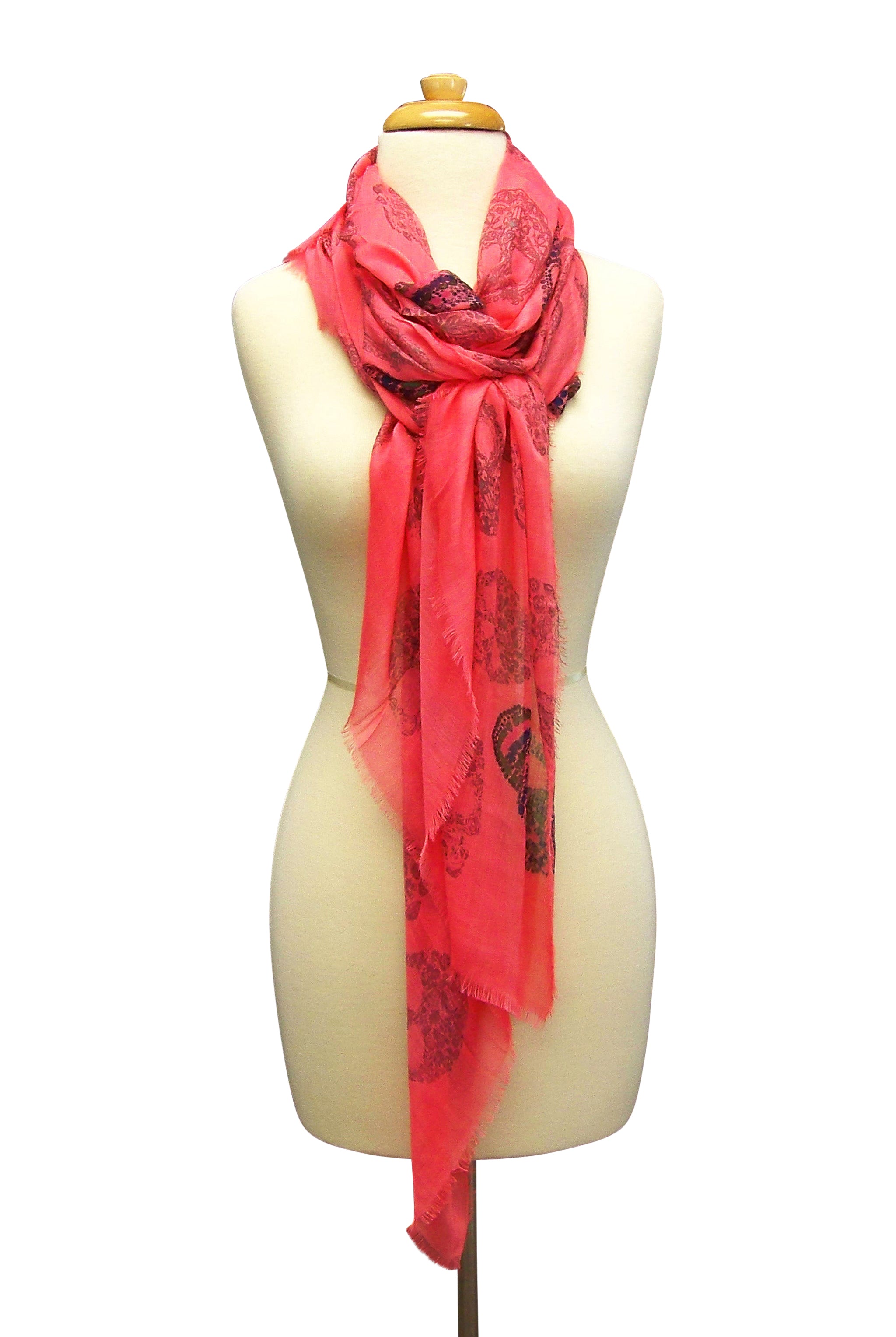 Mannequin Wearing Blue Pacific Frida Cashmere and Silk Scarf with Skulls in Sugar Coral