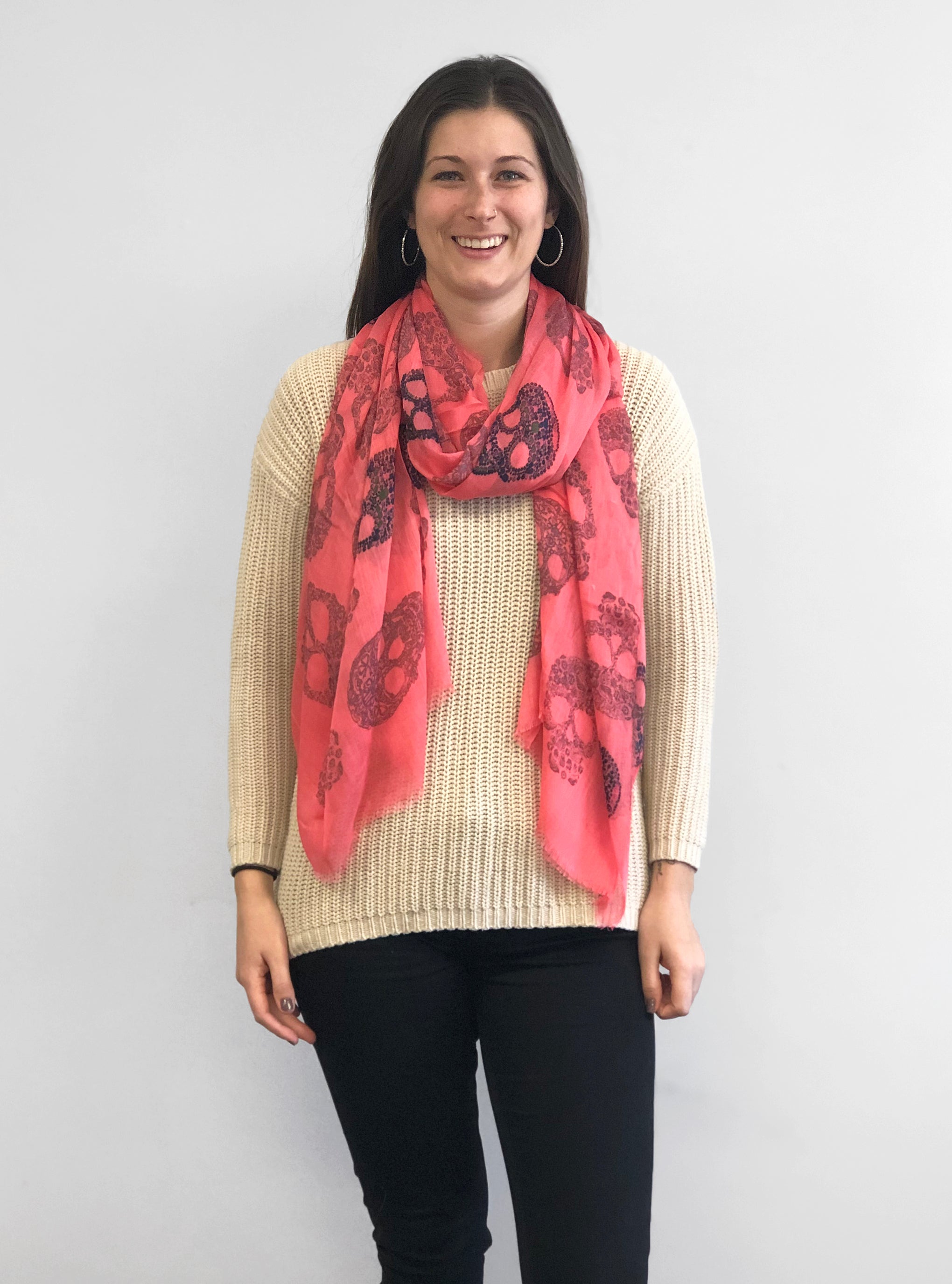 Model Wearing Blue Pacific Frida Cashmere and Silk Scarf with Skulls in Sugar Coral