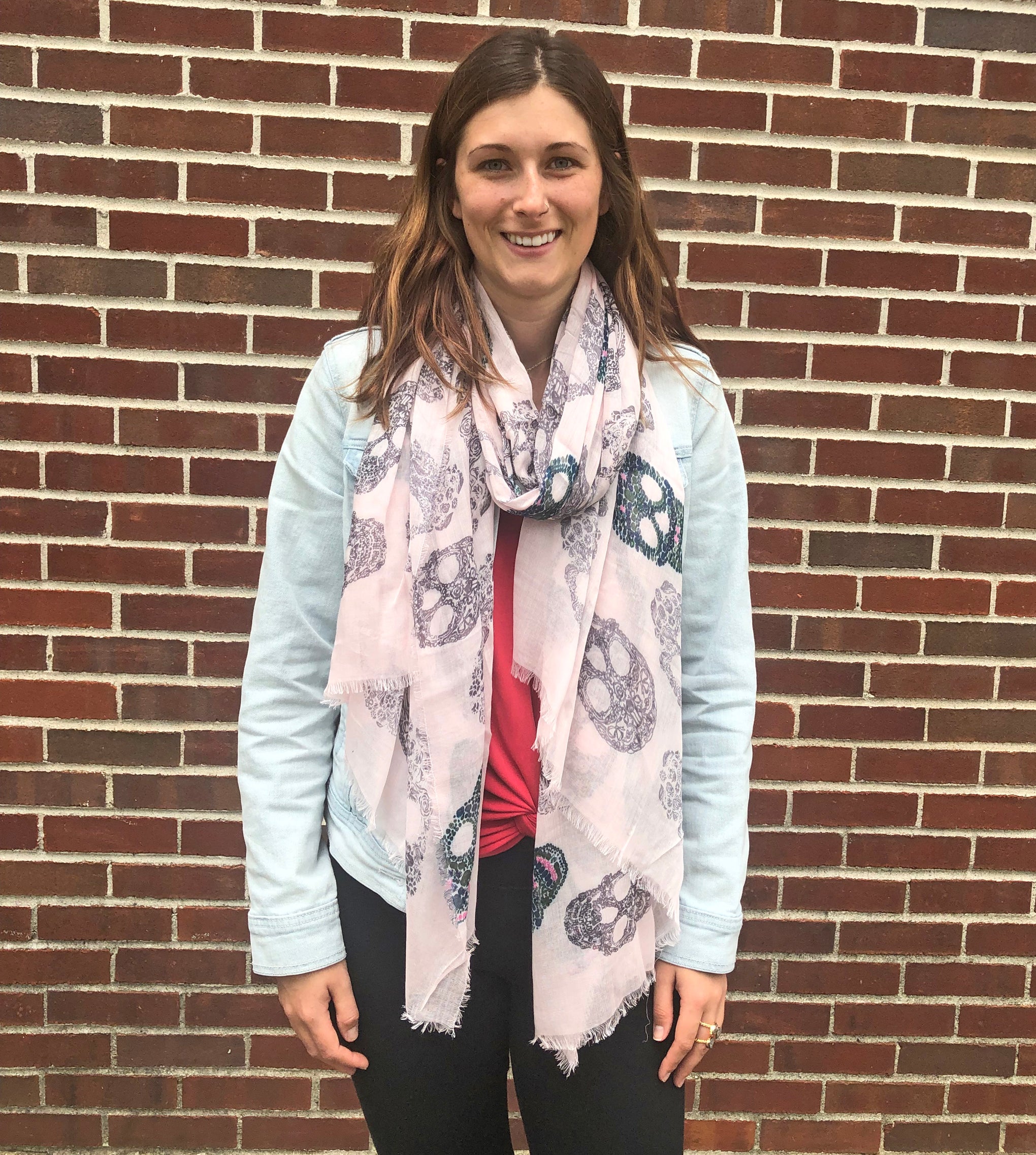 model wearing Blue Pacific Frida Cashmere and Silk Scarf with Sugar Skulls in Pink